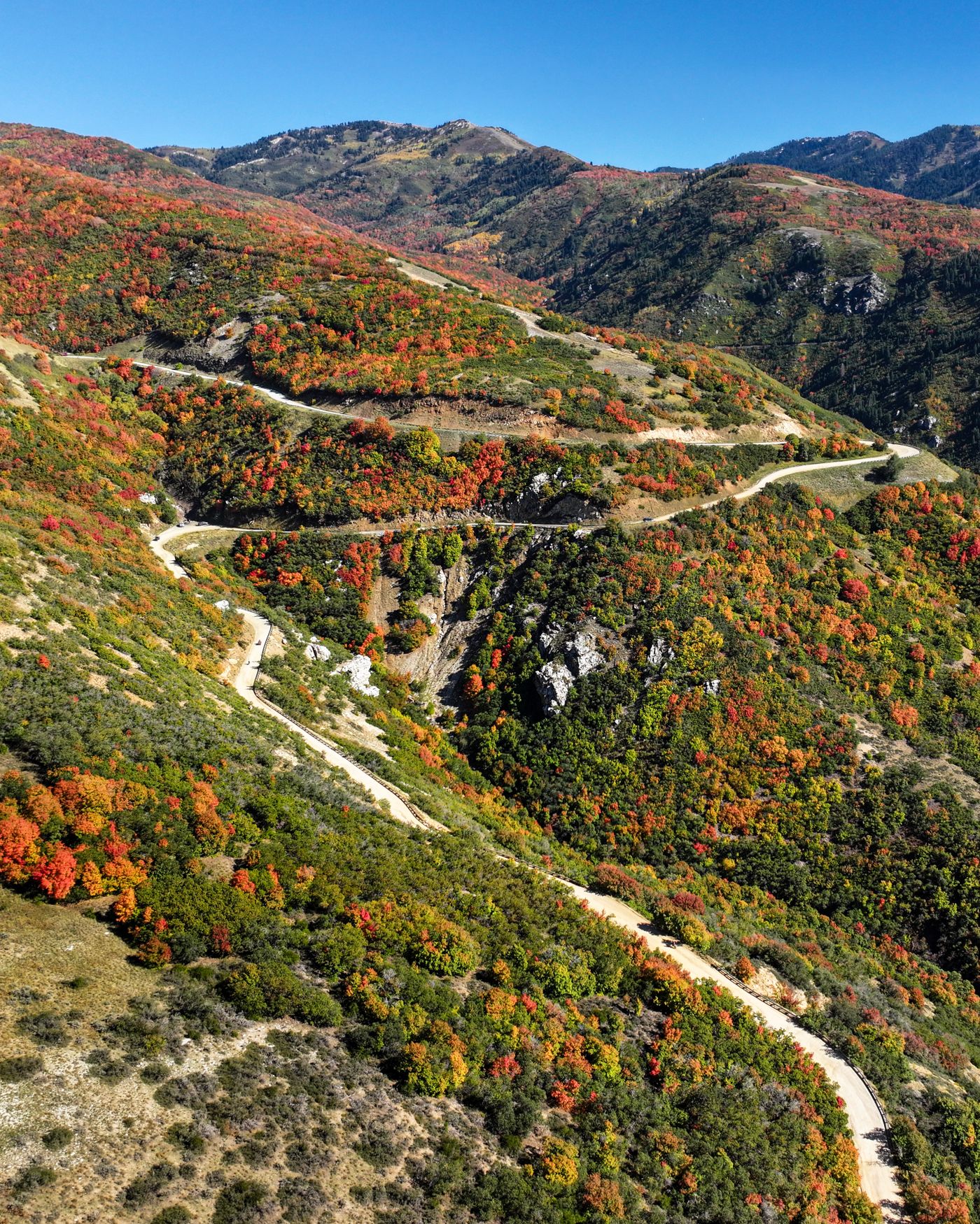 Switchback dirt road through red and green autumn hills in Bountiful, Utah