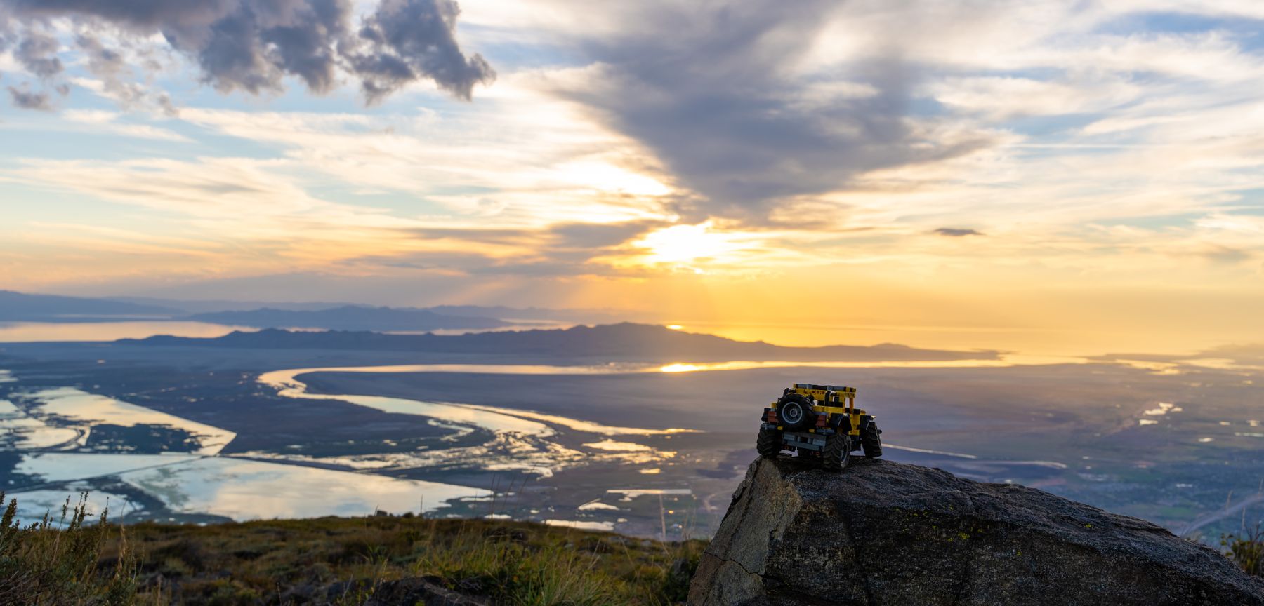Yellow Lego Jeep on a ridge above the Great Salt Lake at sunset