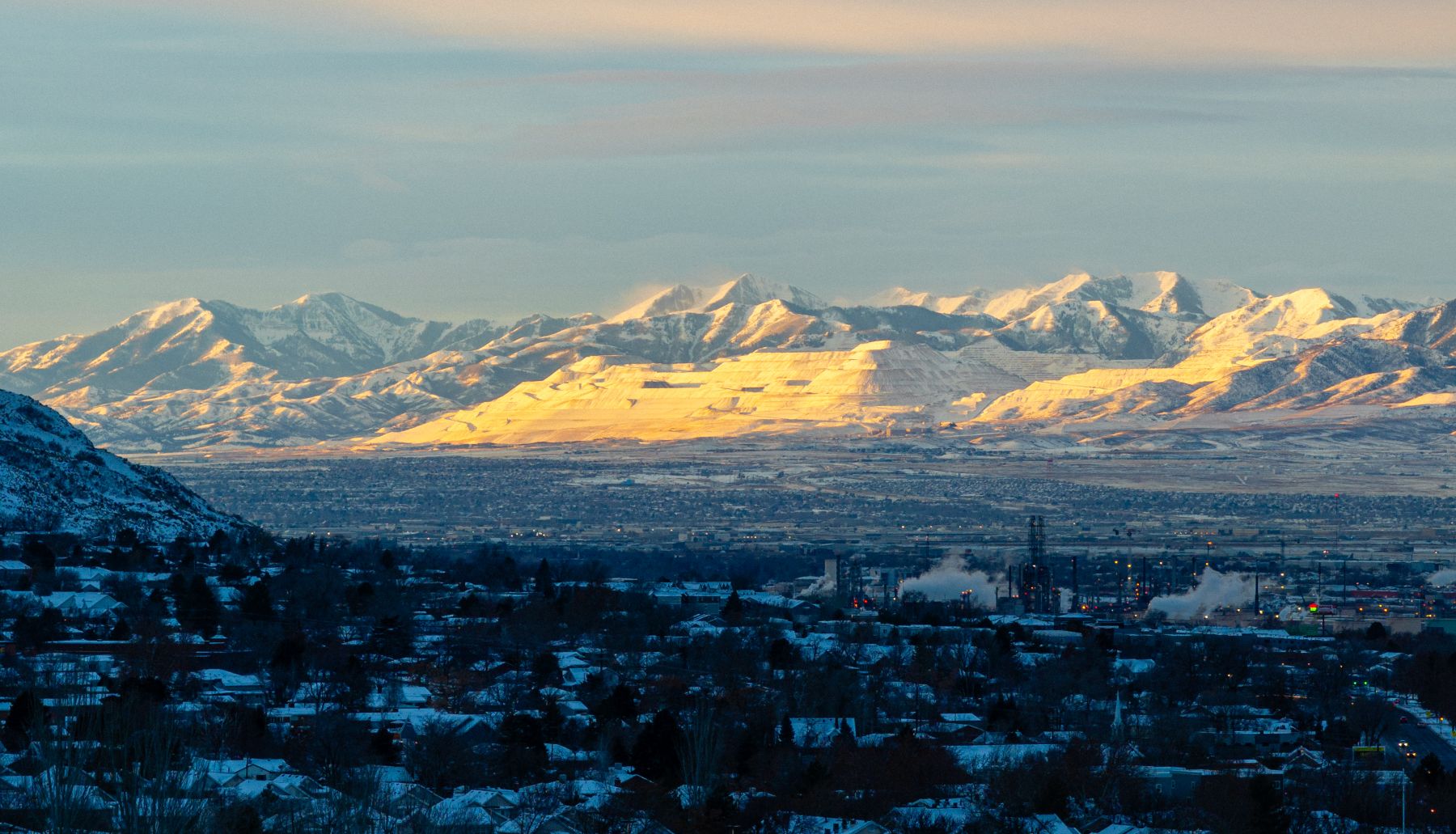 Snow on the Oquirrh Mountains and the Rio Tinto smelter at sunset